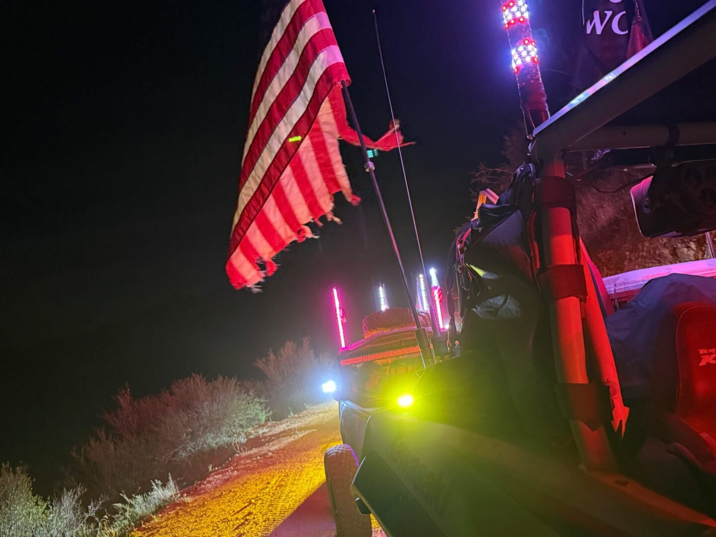 Off-road vehicle with American flag at night