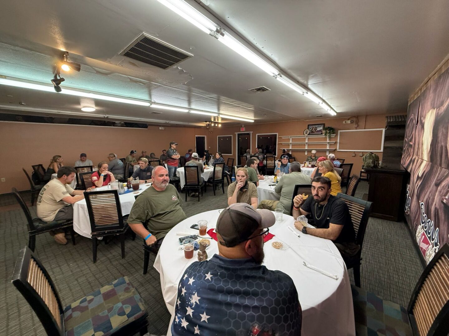 People gathered at banquet tables in hall