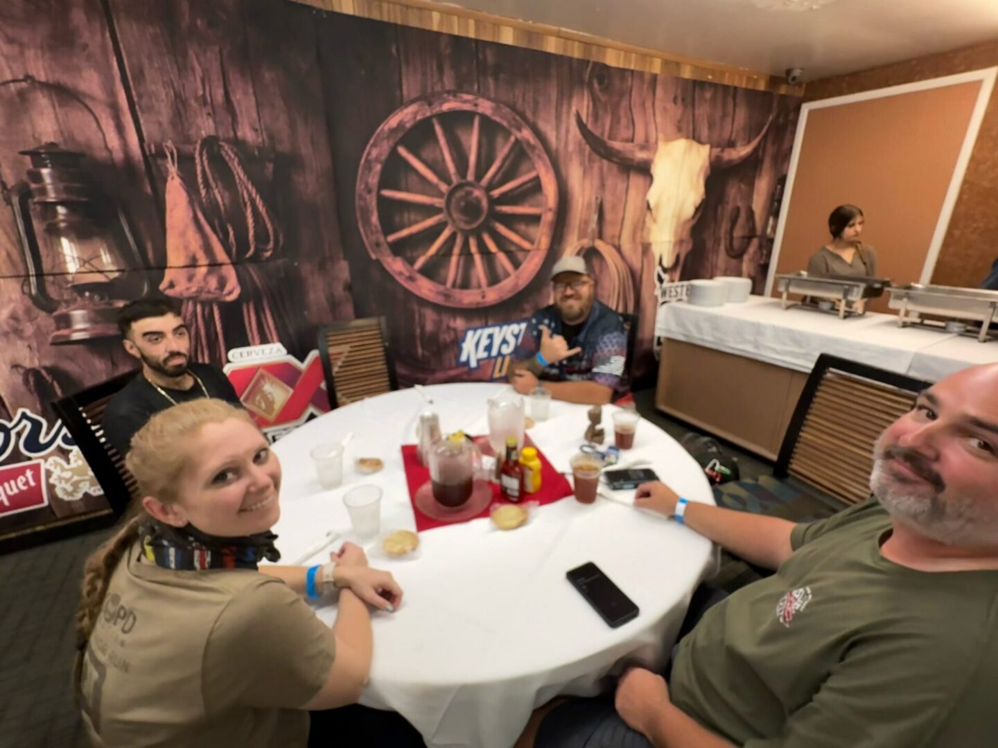 People seated around table in western-themed room