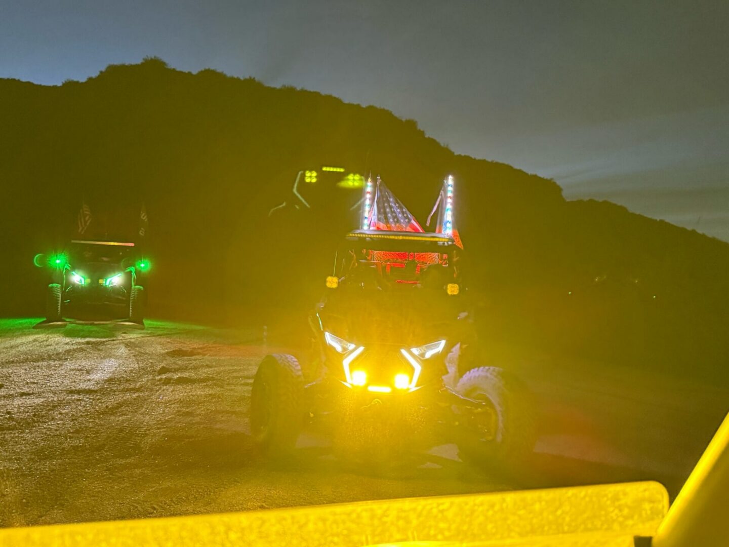 LED-lit off-road buggies at night