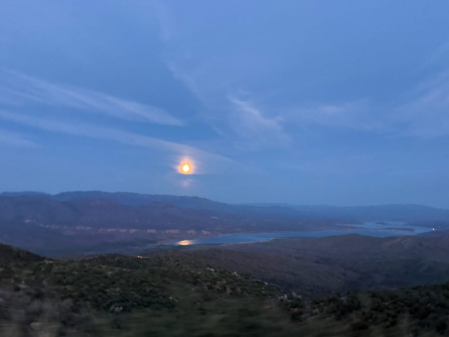 Moonrise over mountain lake at twilight