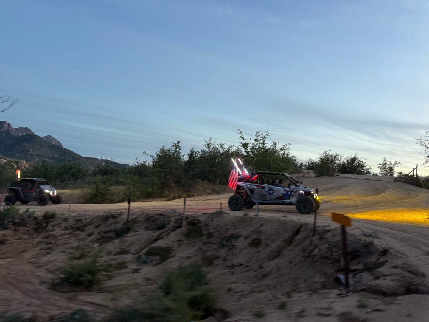UTV with American flag on desert trail