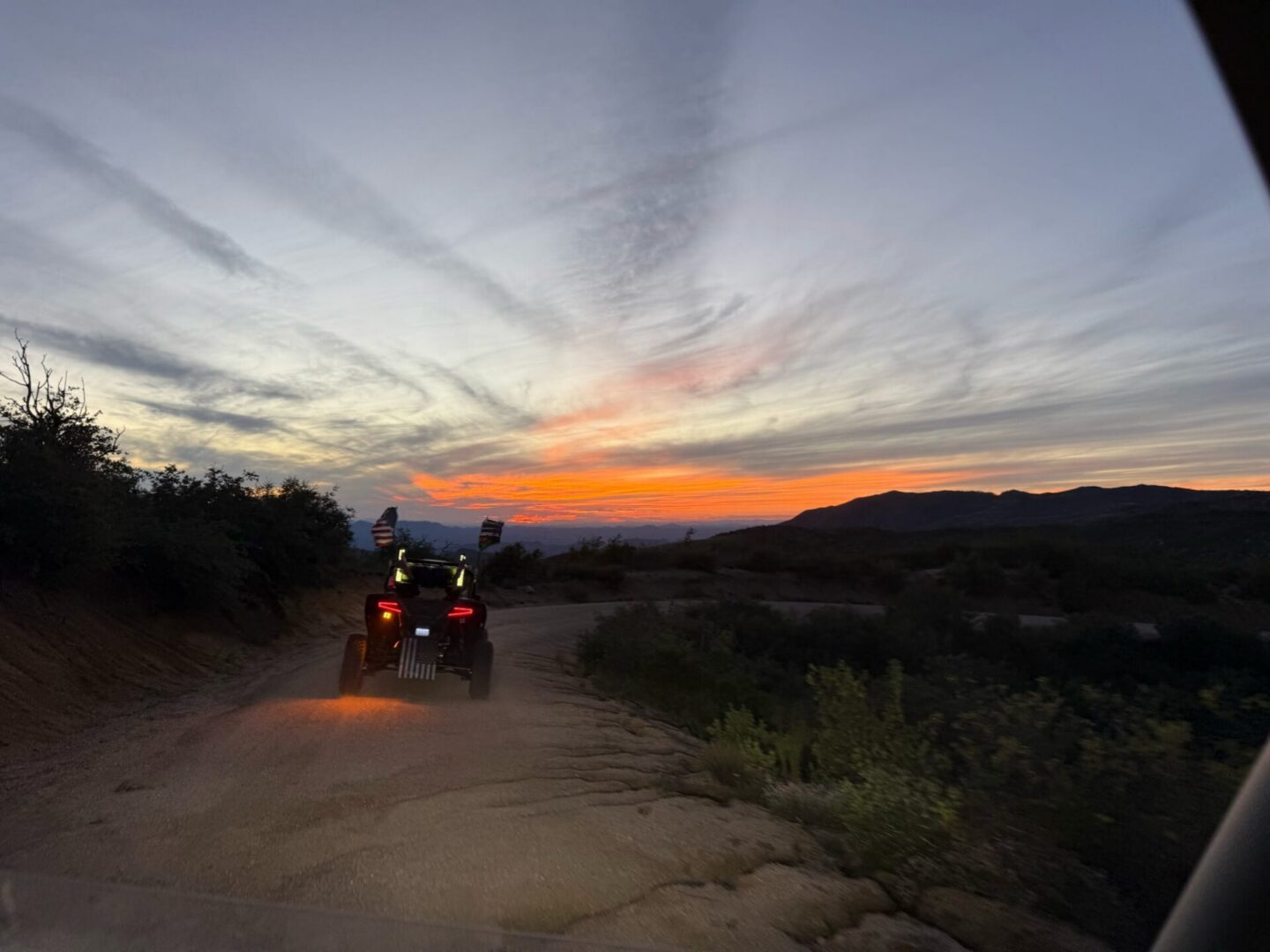 ATV on dirt road at sunset