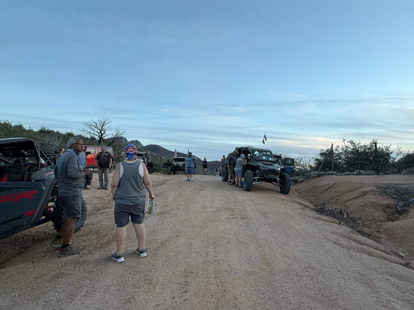 People and off-road vehicles on dirt road