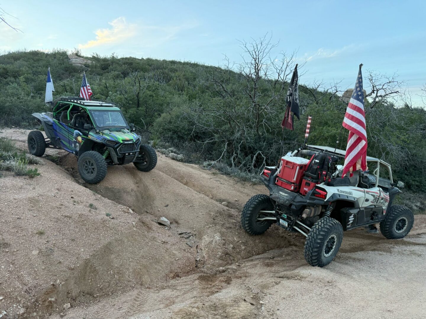 Two off-road UTVs flying American flags