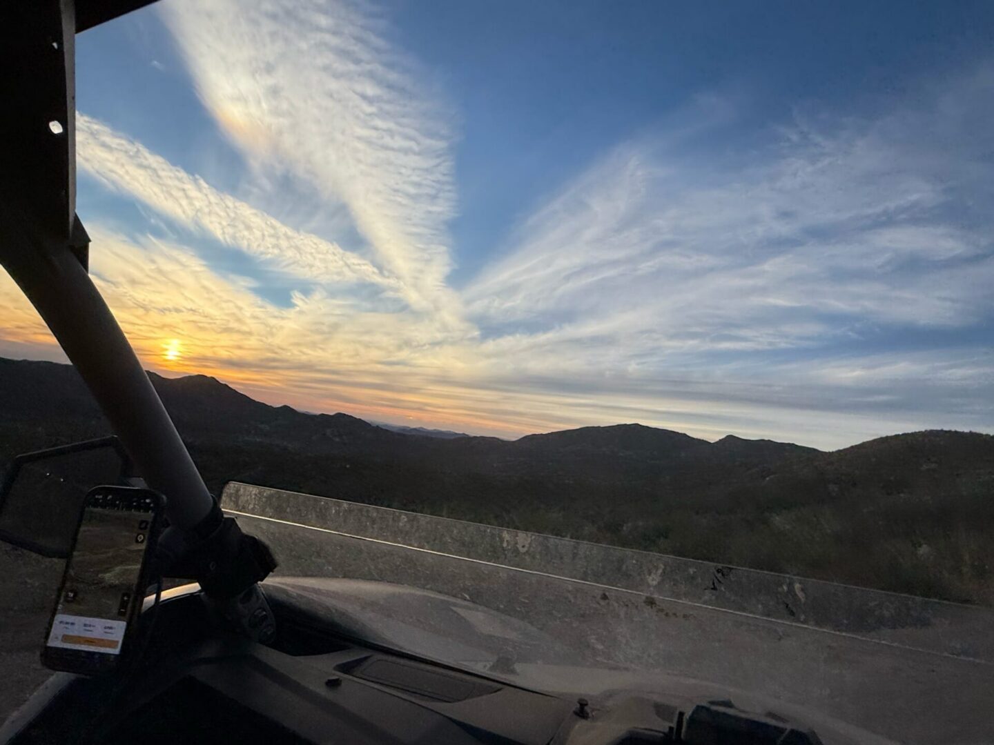 Sunset over mountains from off-road vehicle