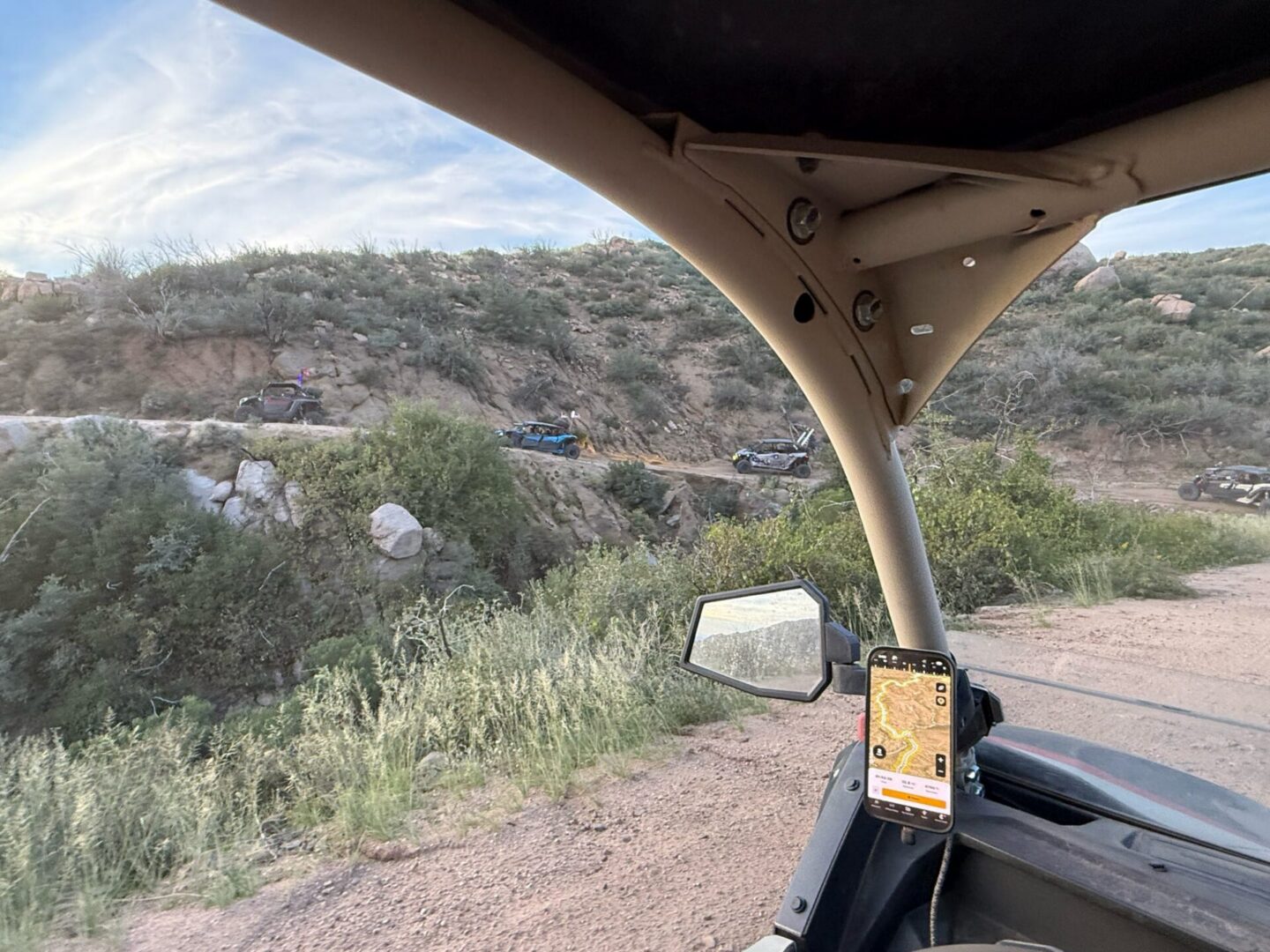 UTV dashboard with phone navigation on desert trail