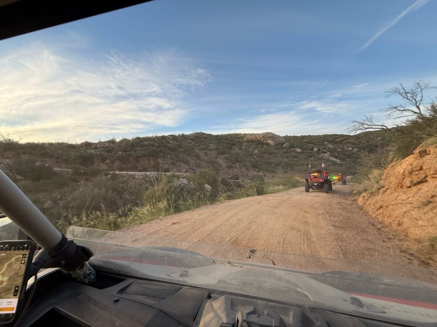 Dashboard view following ATV on desert road