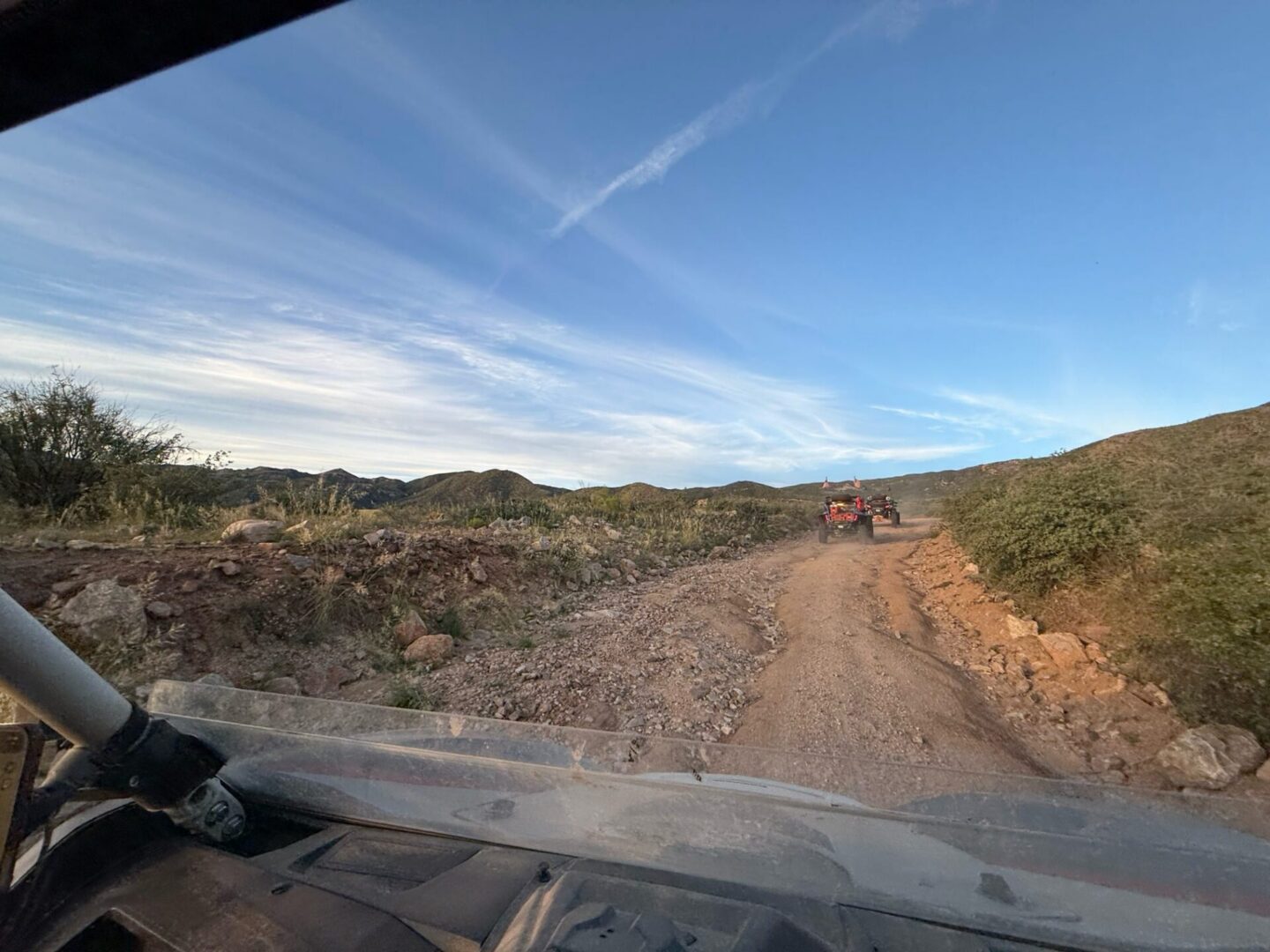 Windshield view of off-road vehicle on trail