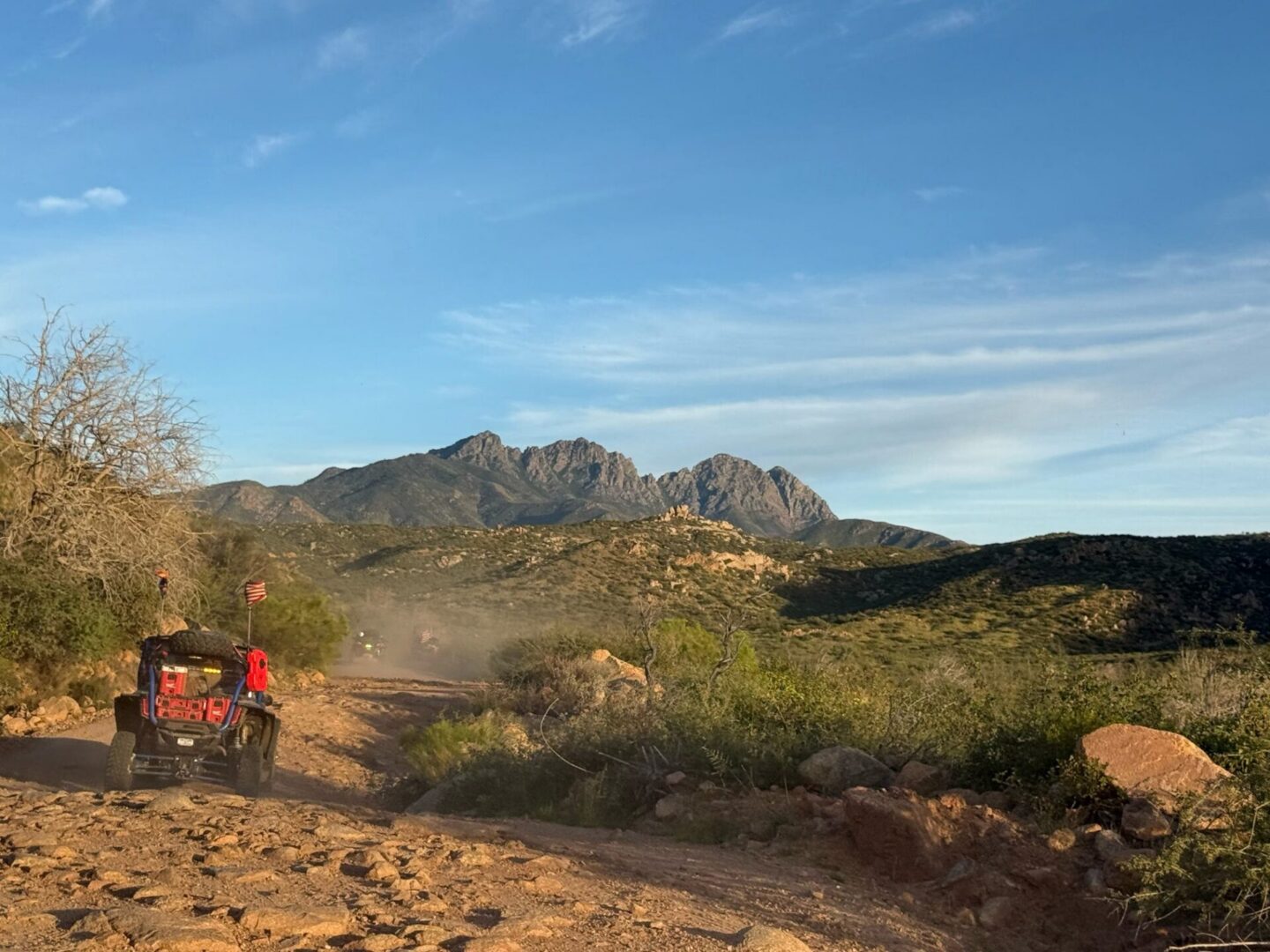UTV driving on desert trail toward mountains
