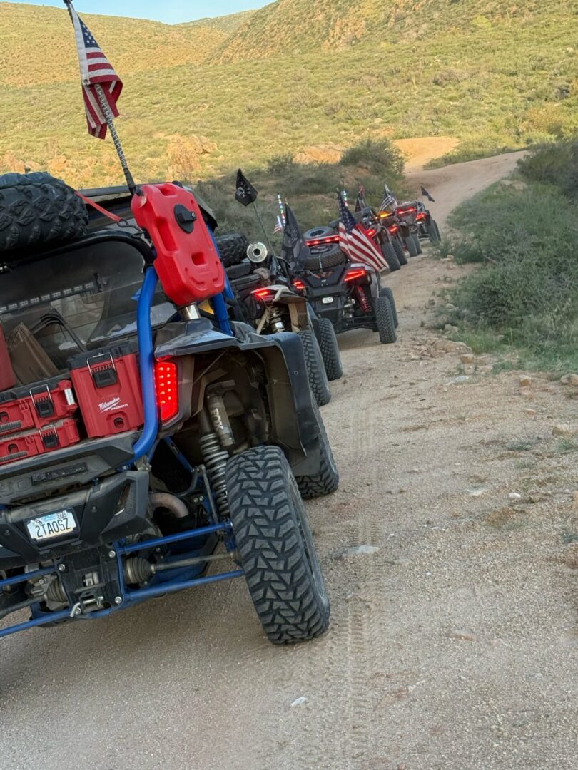 Off-road UTVs with American flags on trail