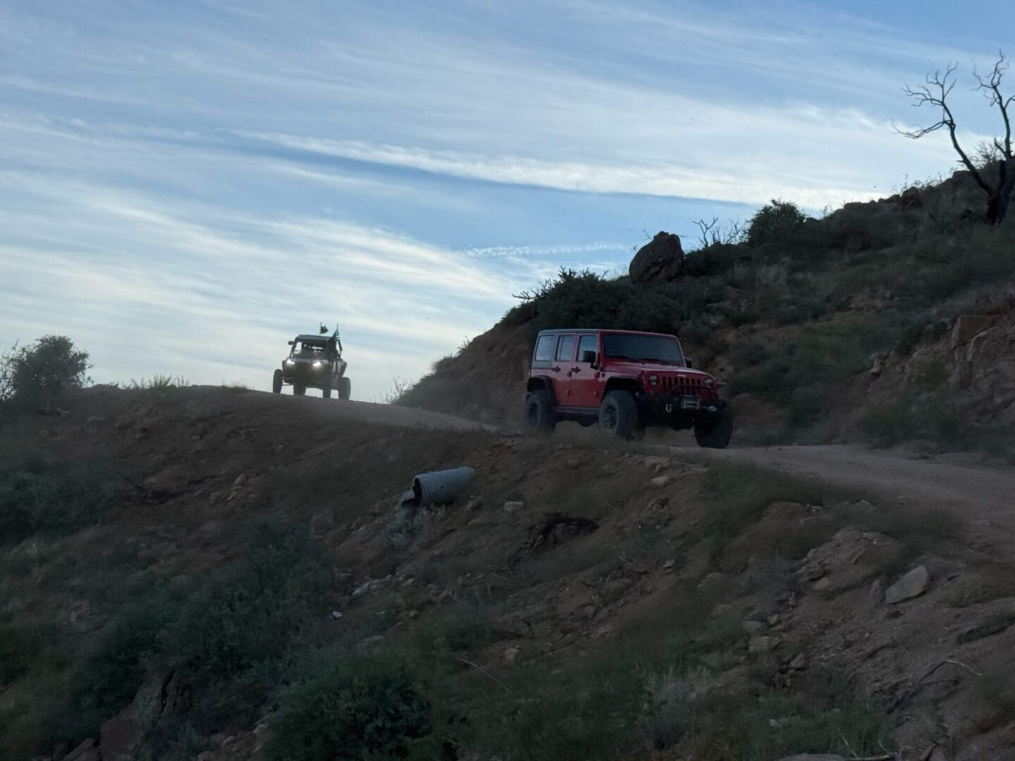 Two Jeeps off-roading on desert dirt trail