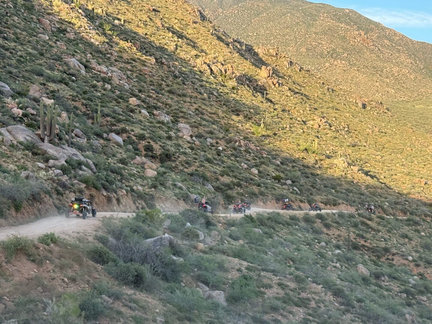 ATVs driving along rocky desert mountain road