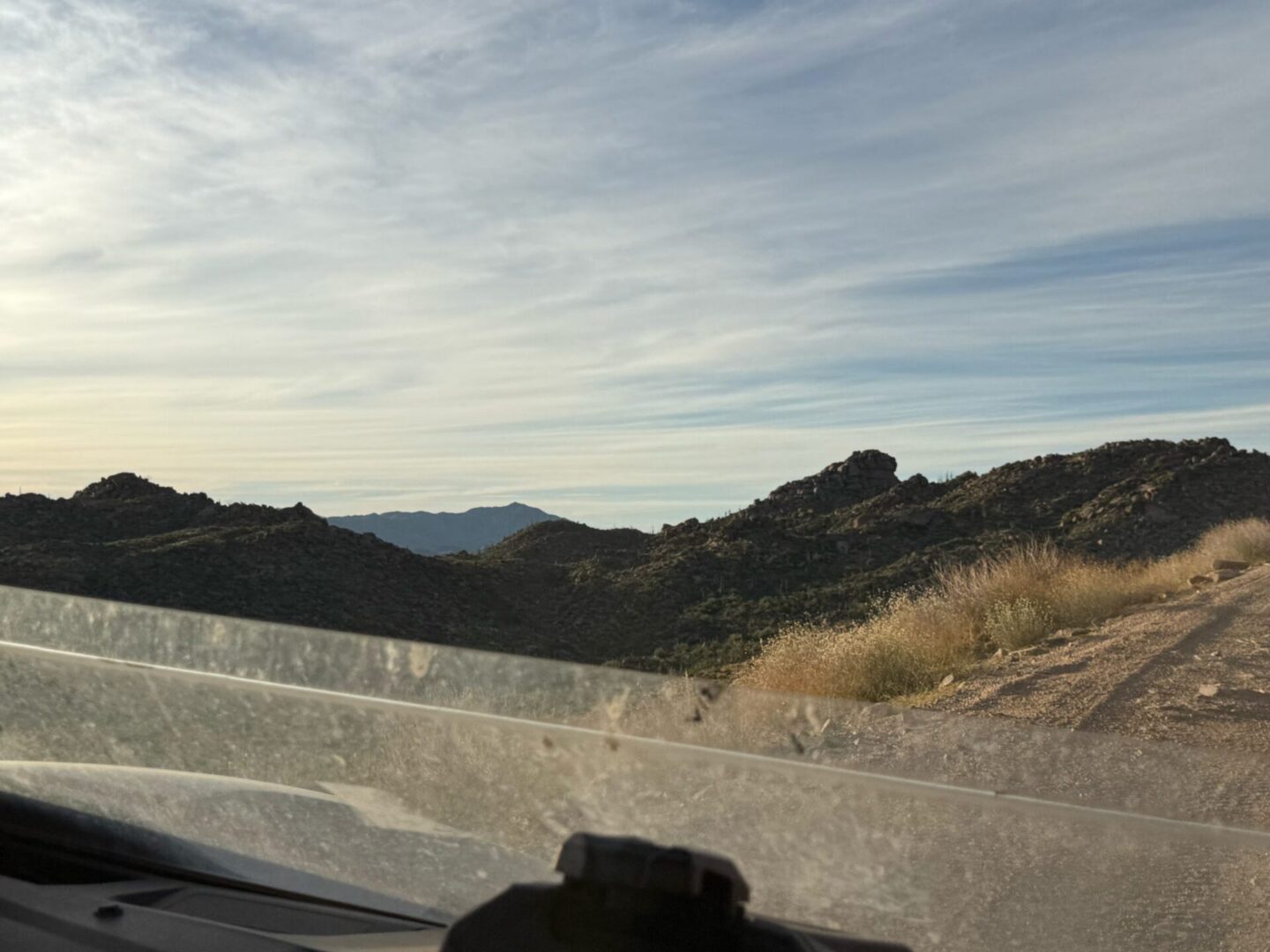 Scenic desert mountain road viewed from vehicle