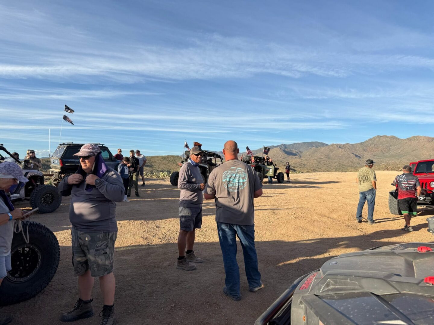 Off-road vehicles and people in desert landscape