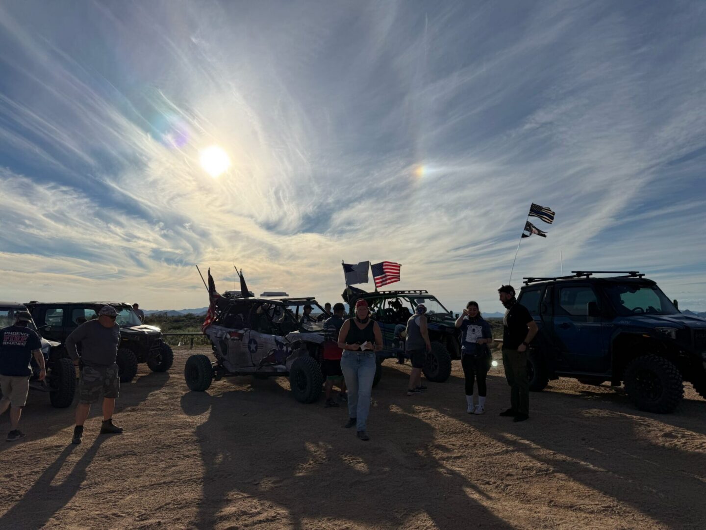Off-road vehicles with people and American flags