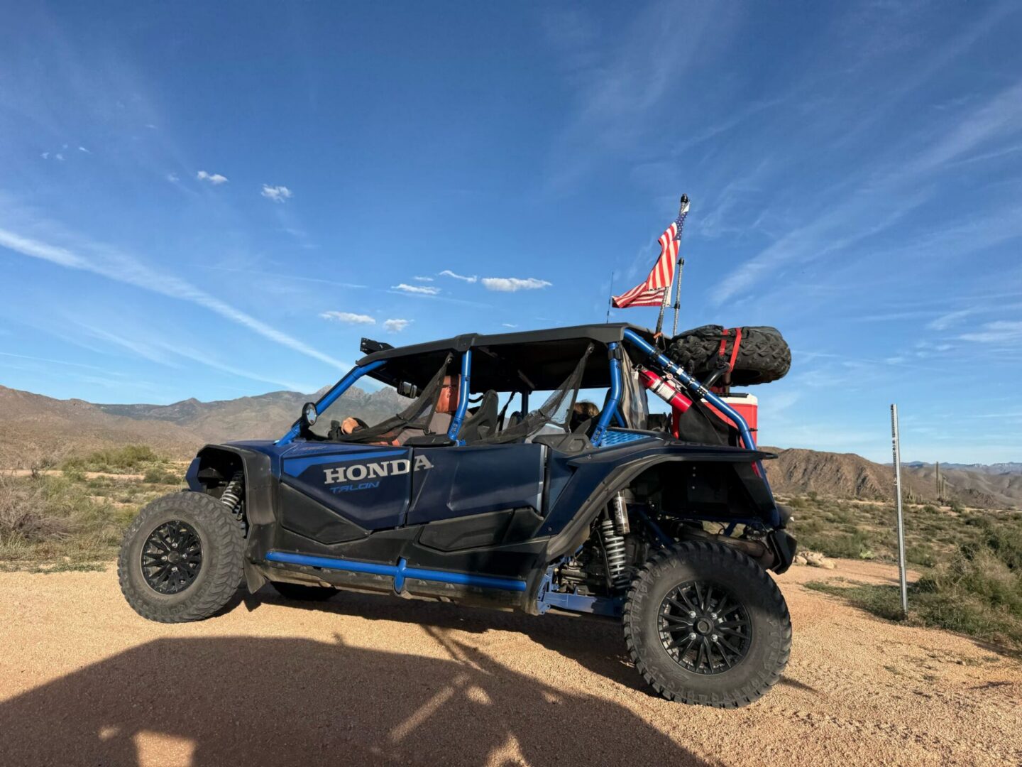 Blue Honda UTV with American flag