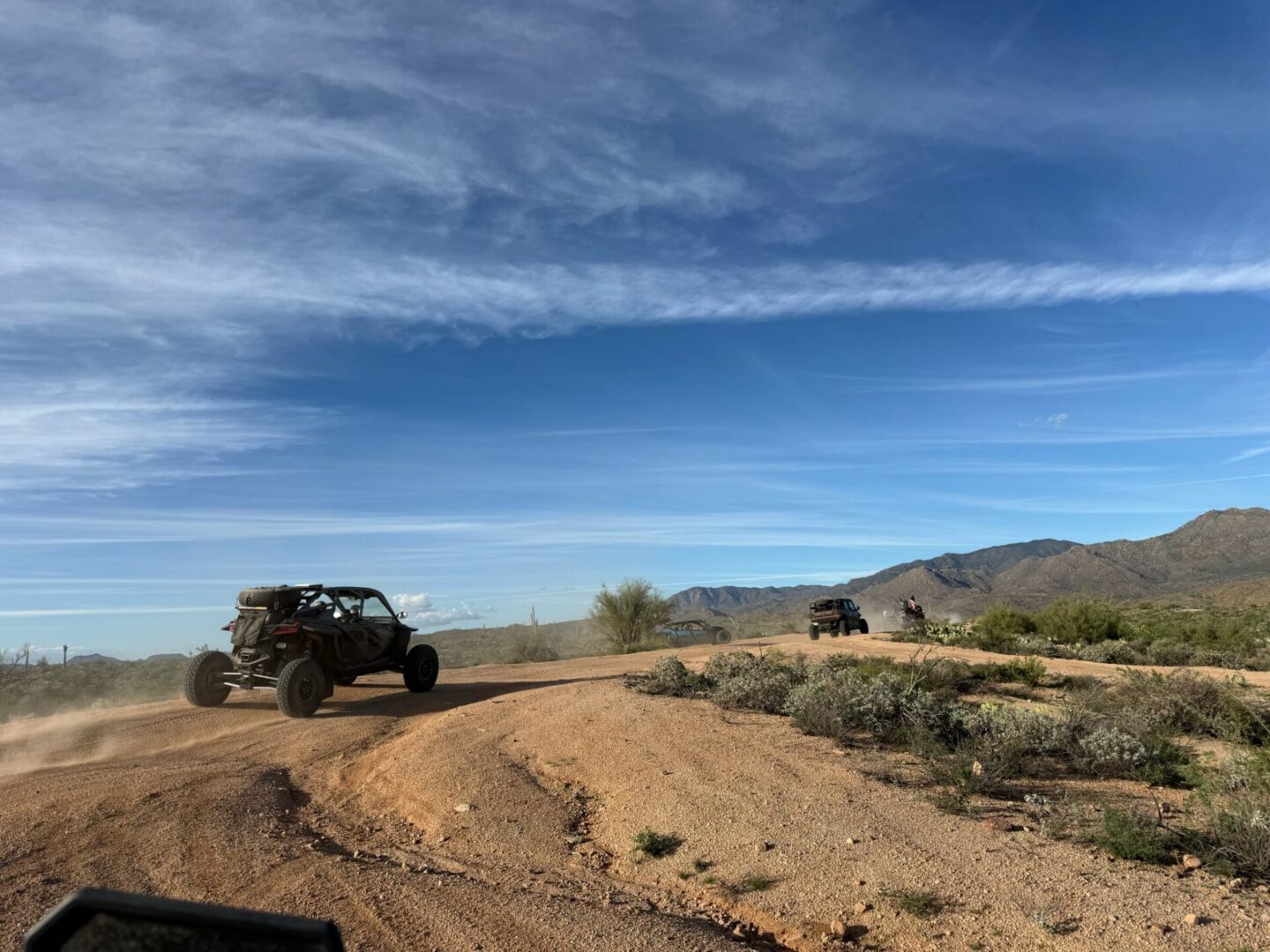 Off-road UTVs driving on desert trail