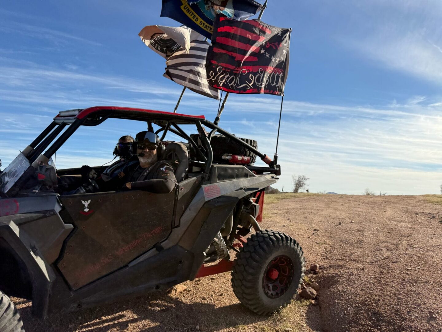 Off-road UTV with flags on dirt trail