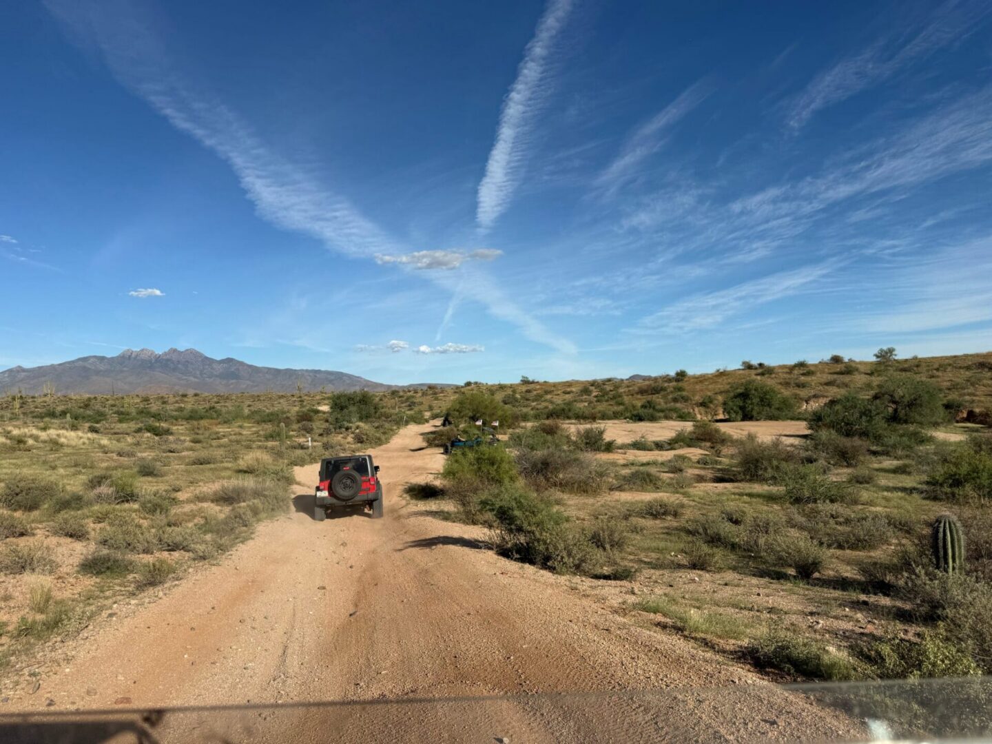 Jeep driving on desert dirt road