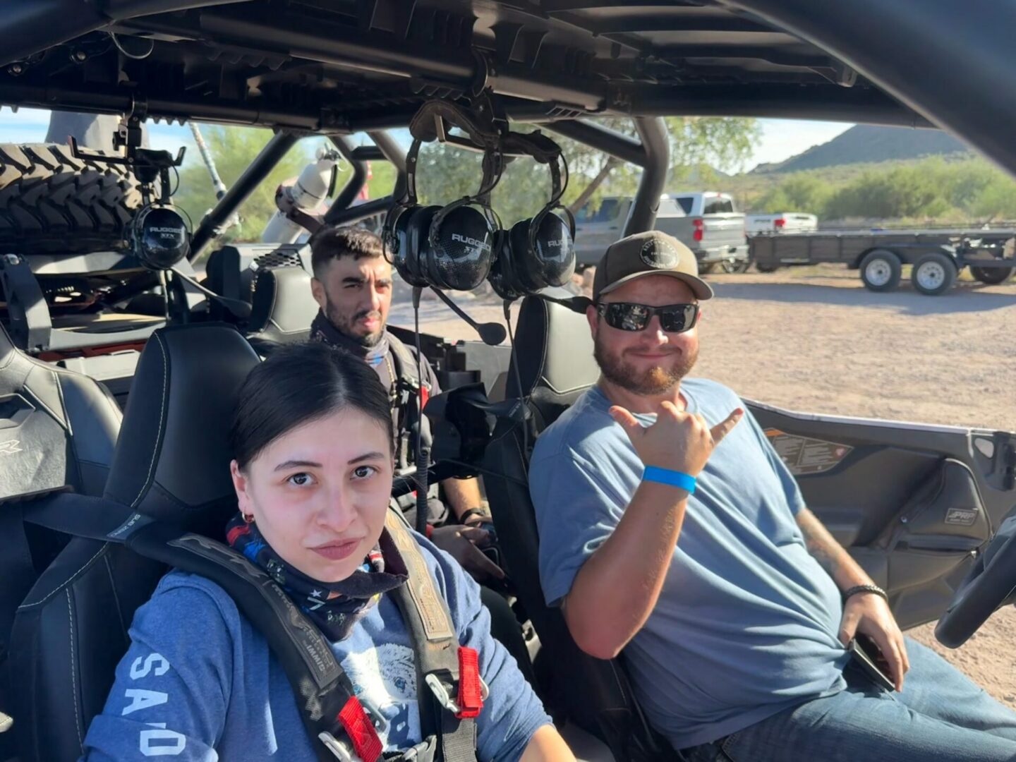 Three people seated in off-road vehicle