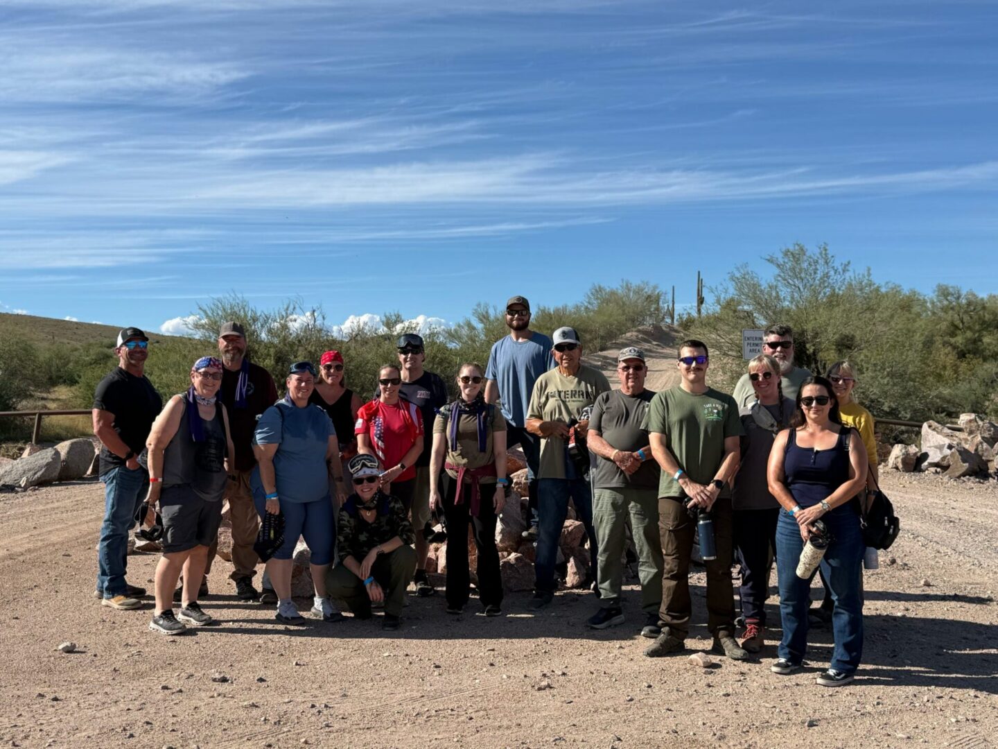 Group of people posing on desert trail