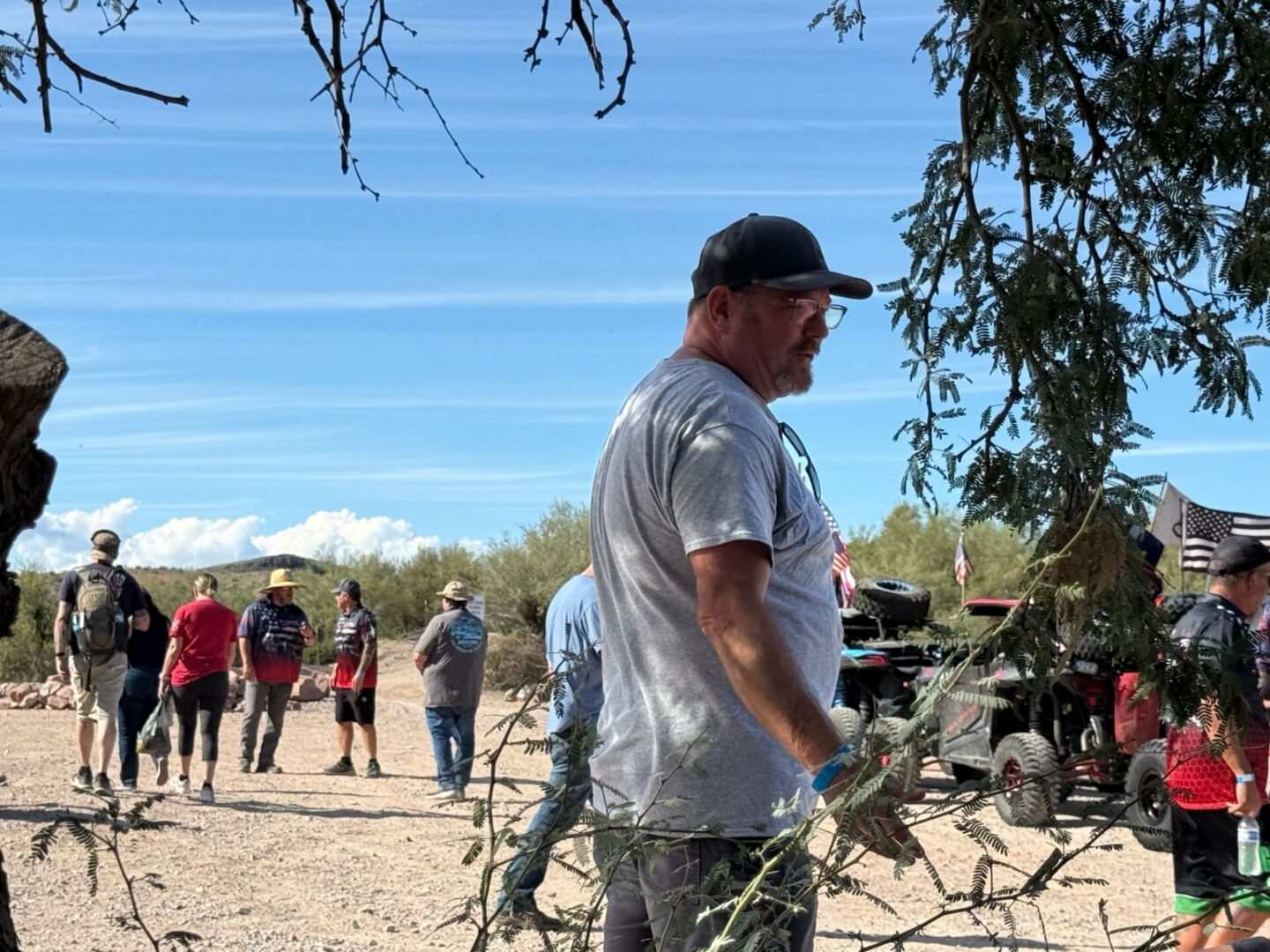 People gathered outdoors near off-road vehicles