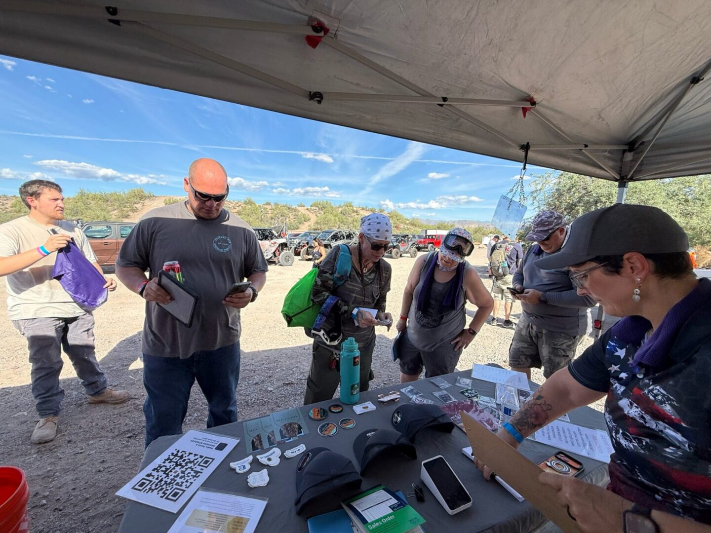 People browsing outdoor gear at vendor booth