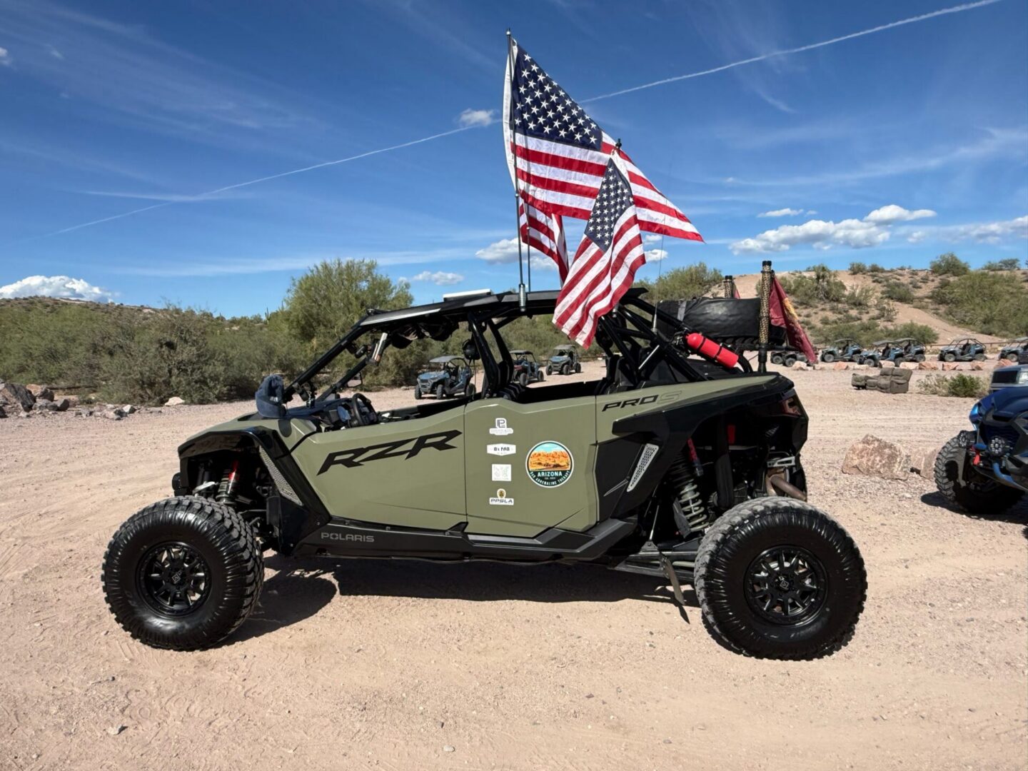 Green Polaris RZR UTV with American flags
