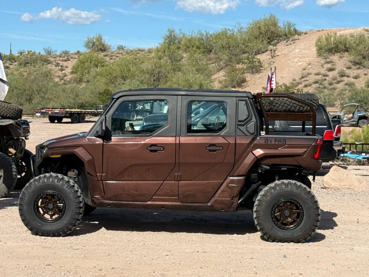 Brown four-door off-road UTV in desert
