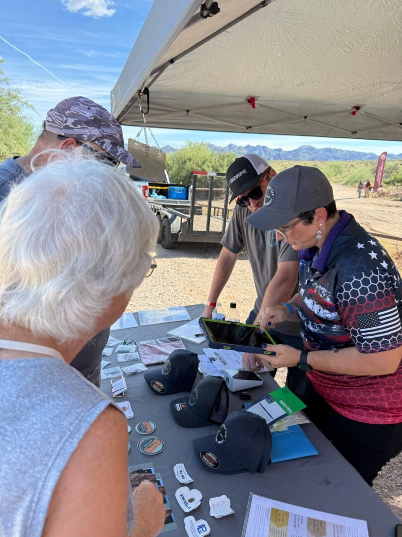Vendor showing tablet to customers at booth