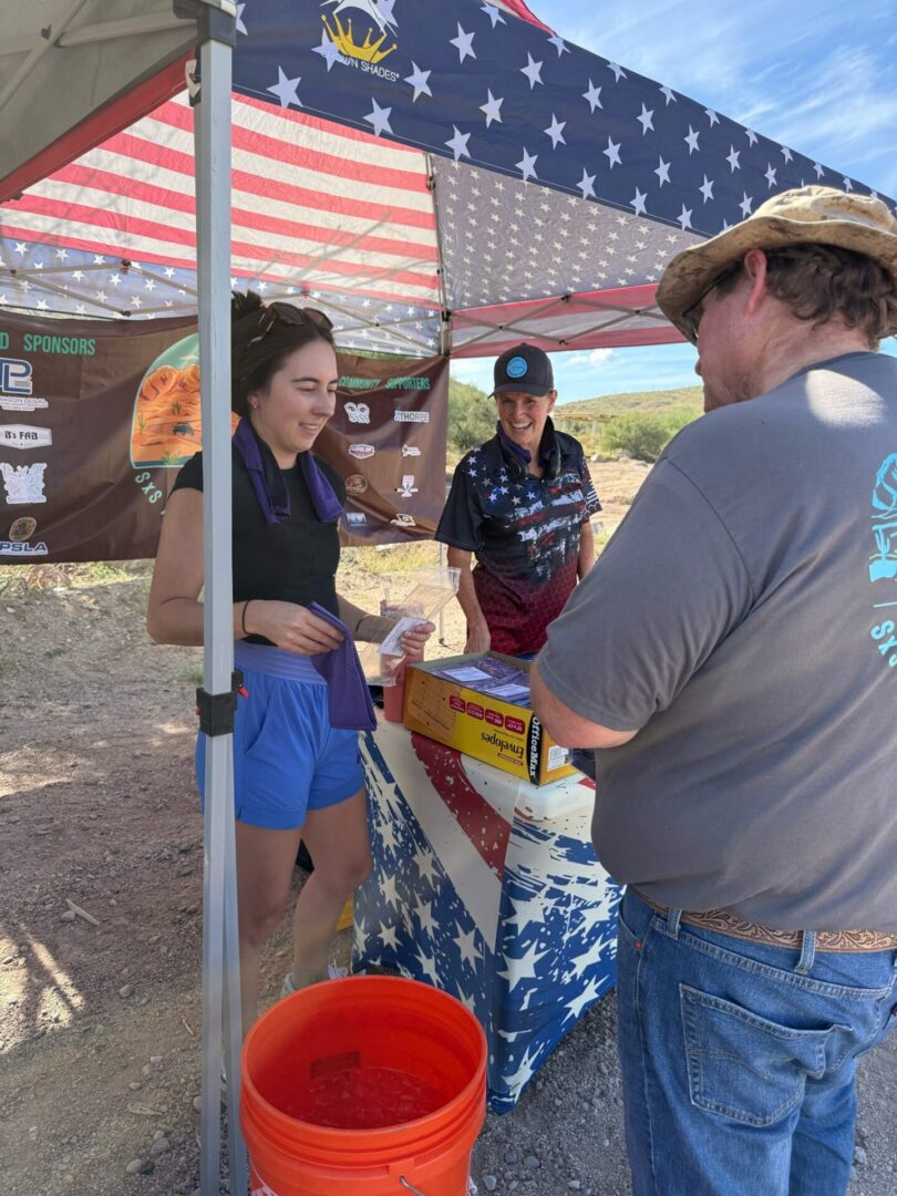 People at American-flag decorated outdoor vendor booth