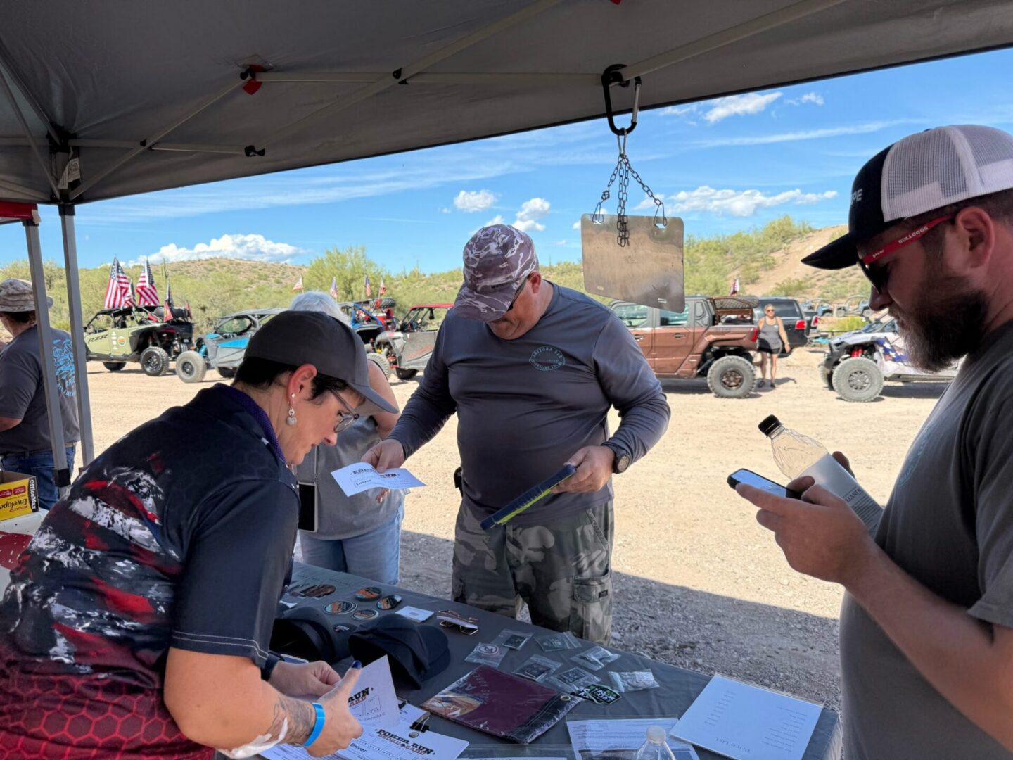 Outdoor event registration table with off-road vehicles