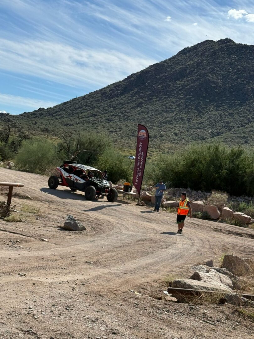 Off-road buggy in desert with mountain backdrop