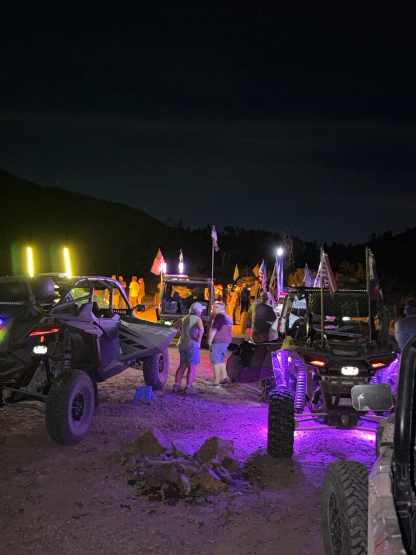 Nighttime UTV rally with purple LED lights