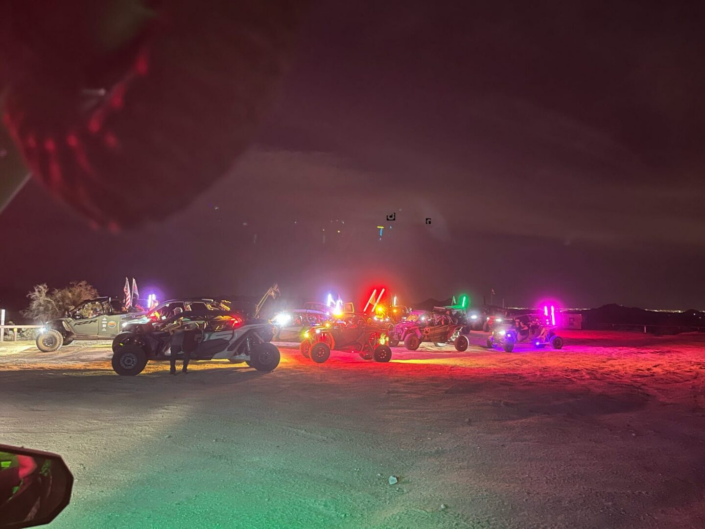 Dune buggies at night with colorful lights