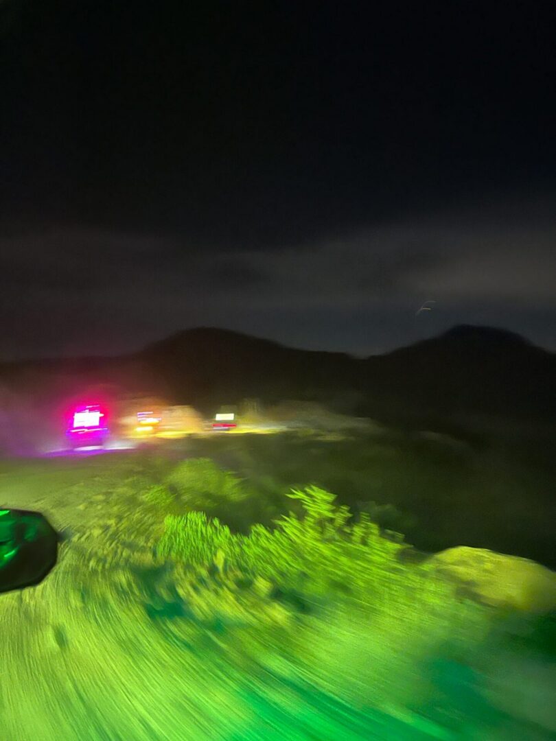 Night roadside scene with flashing emergency lights