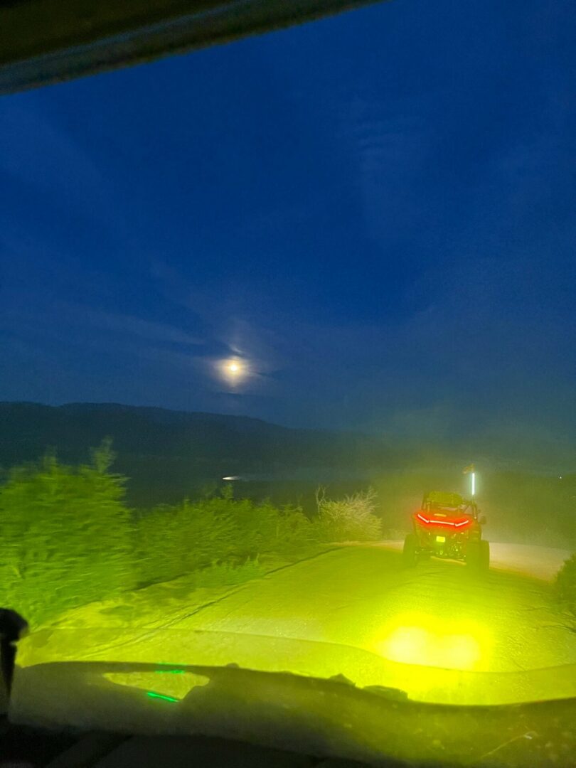Moonlit road with bright off-road vehicle