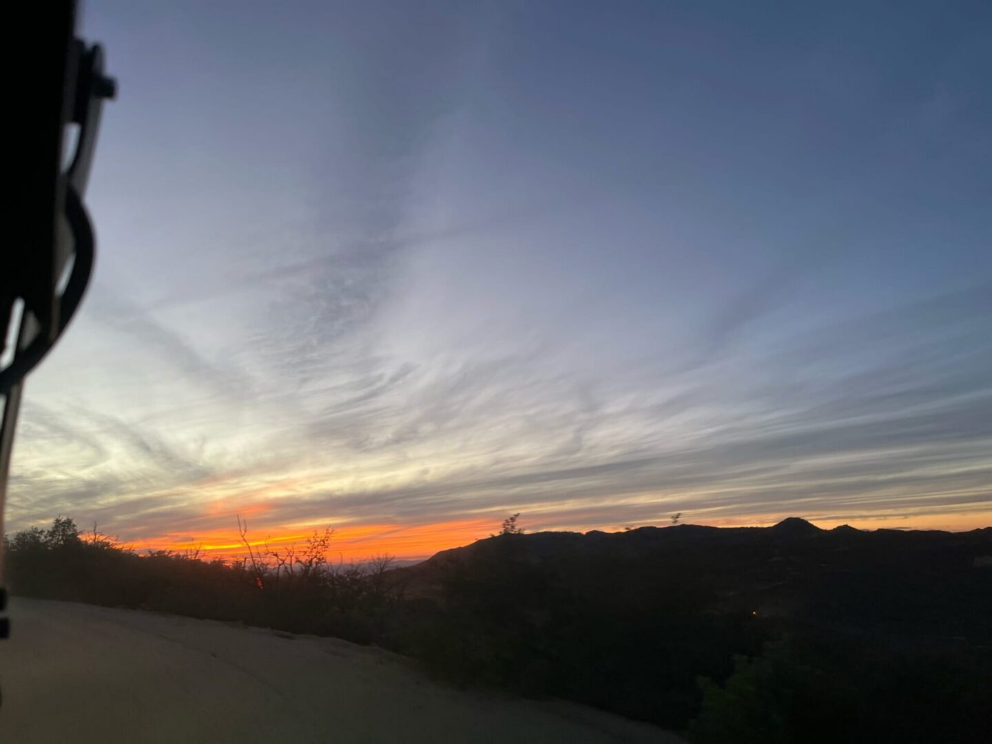 Sunset over rolling hills with colorful sky