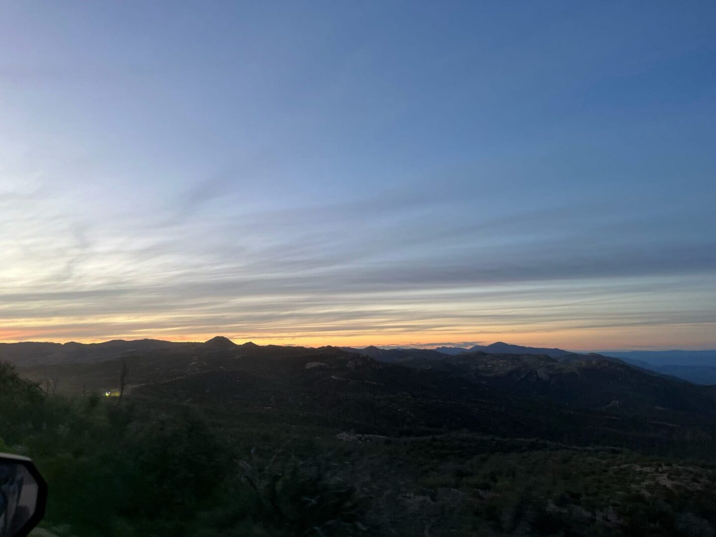 Sunset over rolling mountain ridges