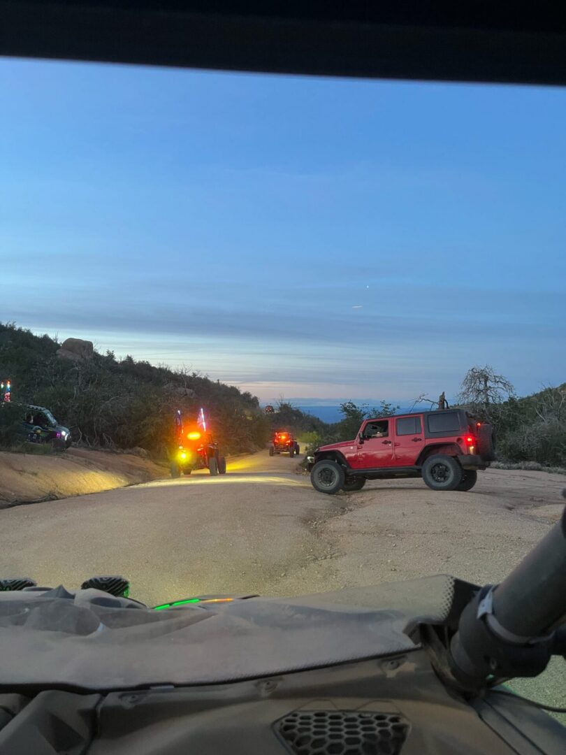 Red Jeep off-road at dusk