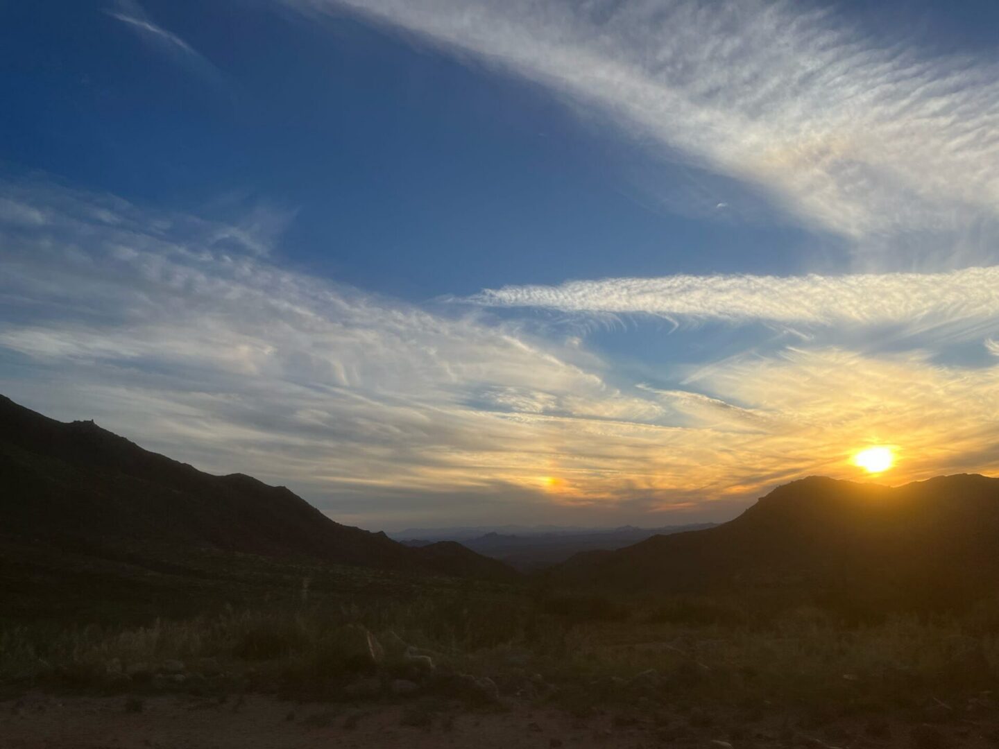Sunset over mountain valley with dramatic clouds