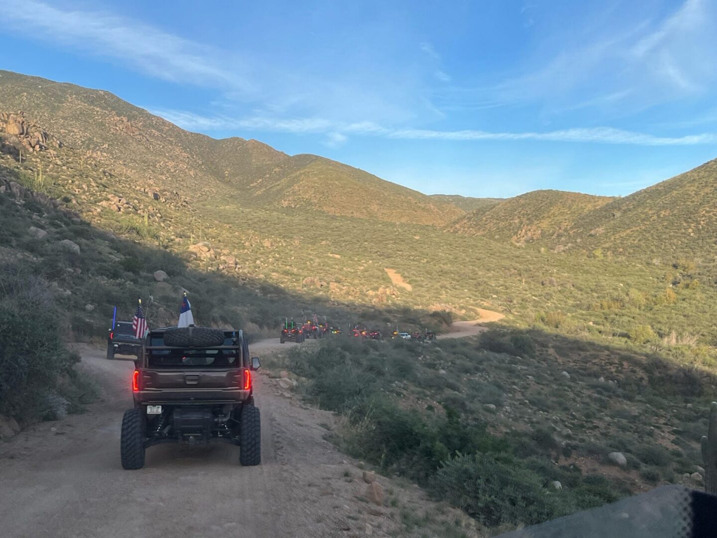 Off-road trucks driving on desert mountain trail