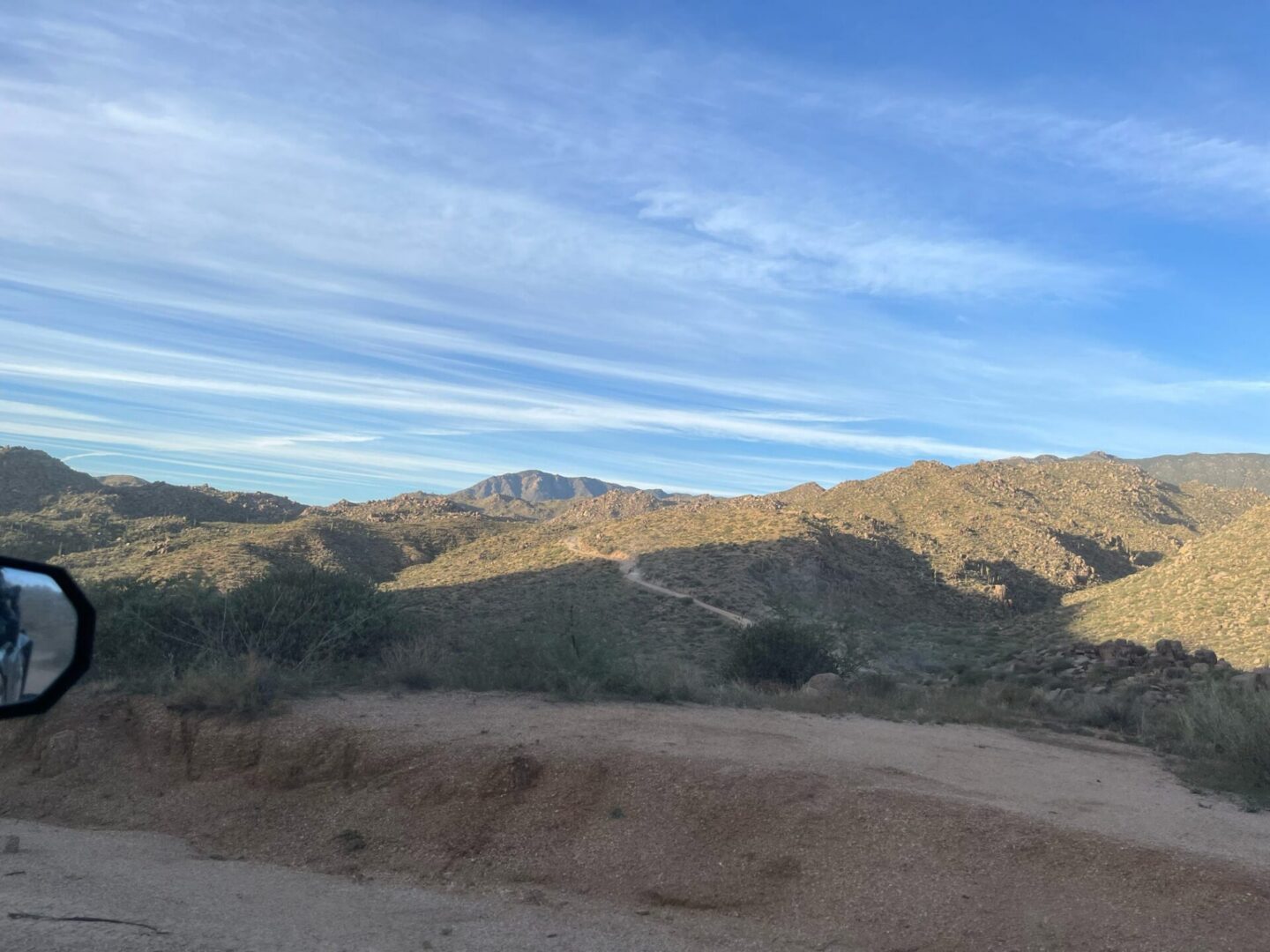 Dirt road through desert mountain landscape