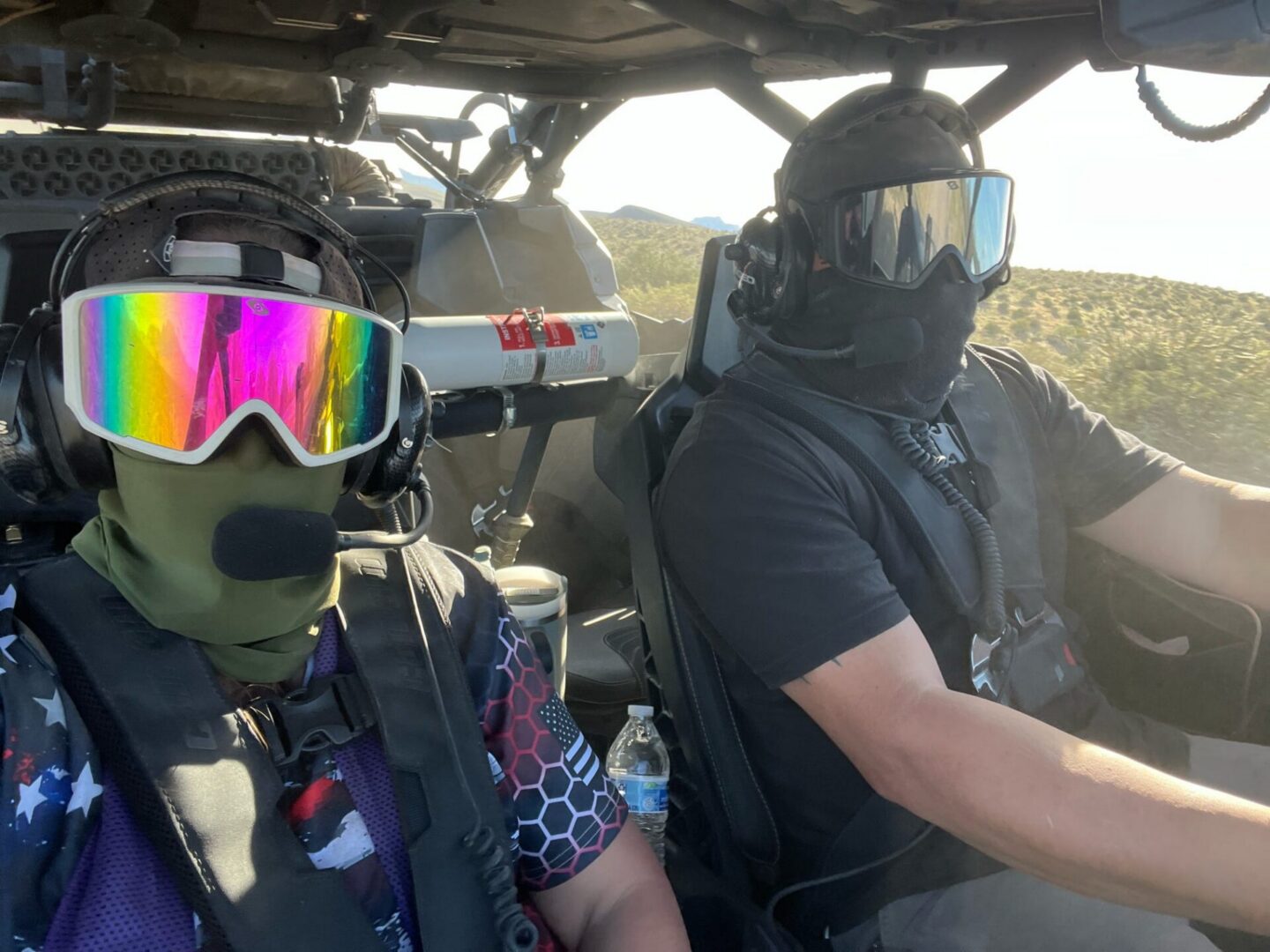 Two masked riders in off-road vehicle
