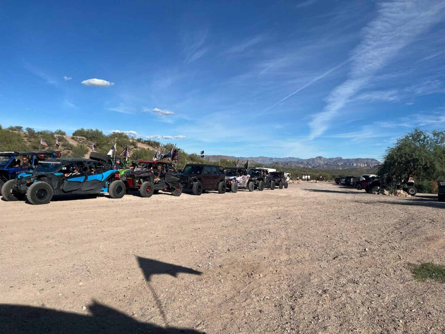 UTVs parked in a desert dirt lot
