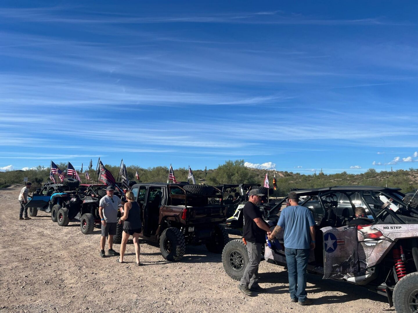 Line of off-road UTVs with American flags
