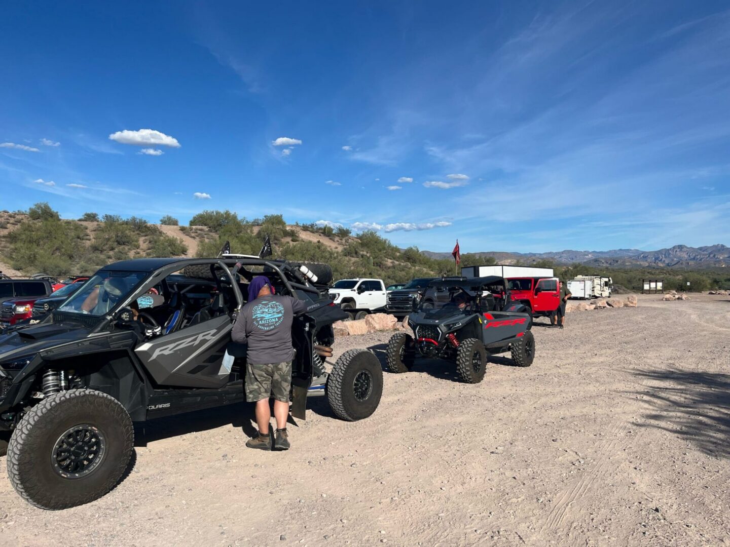 Off-road UTVs parked at desert trailhead