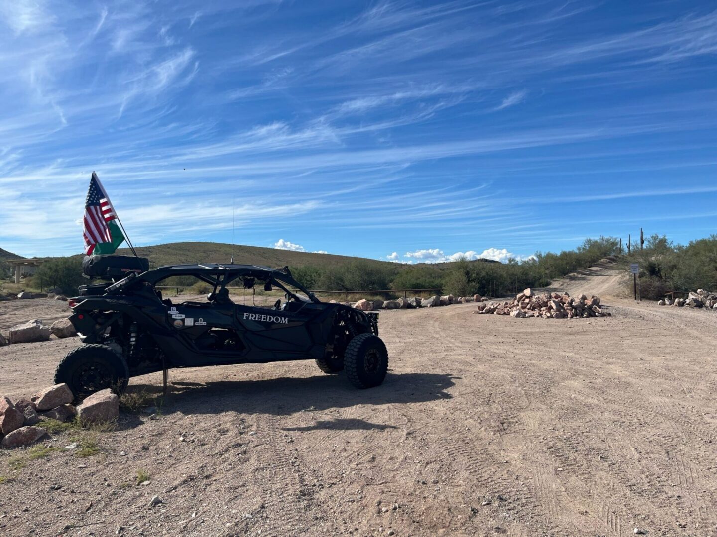 Off-road UTV with American flag on desert road