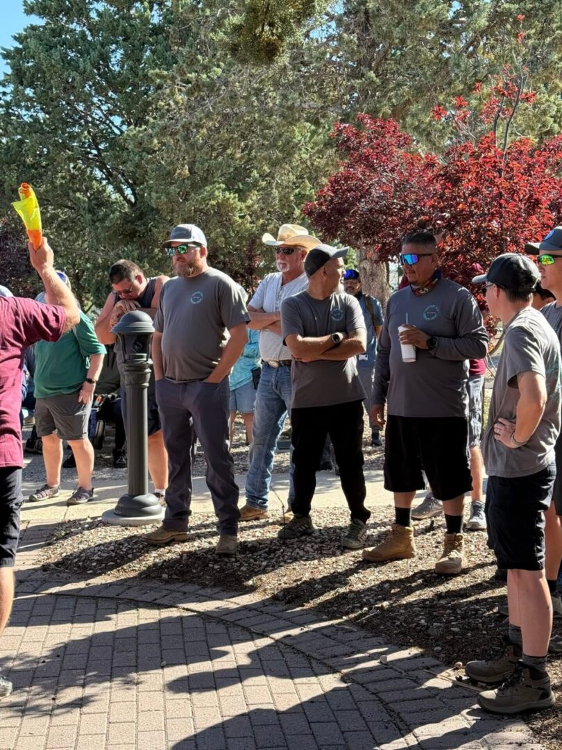 Group of men in gray shirts outdoors